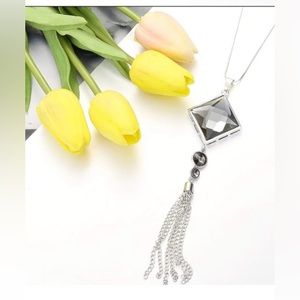 Long silver necklace with large black/grey💎 followed by 2 smaller ones w tassel